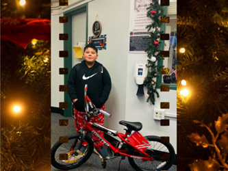Picture of boy standing by a bike